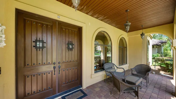 a view of a porch with chairs and couches with wooden floor