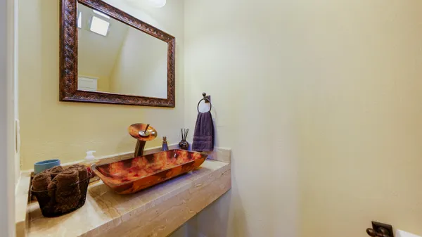 a spacious bathroom with a tub sink and mirror