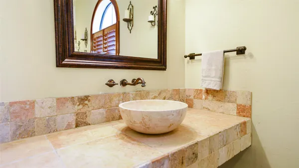 a view of a hallway with dining area and chandelier