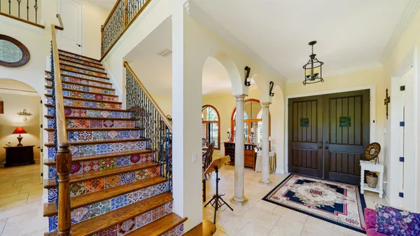 a view of a dining room with furniture a chandelier and wooden floor