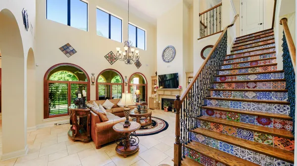 a kitchen with stainless steel appliances granite countertop a kitchen island a stove a dining table and chairs with wooden floor