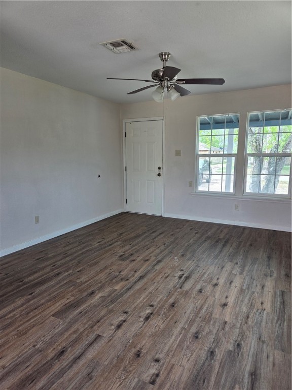 2532 Milo Street Corpus Christi, TX 78415 - Photo 2 of 7 an empty room with wooden floor fan and windows
