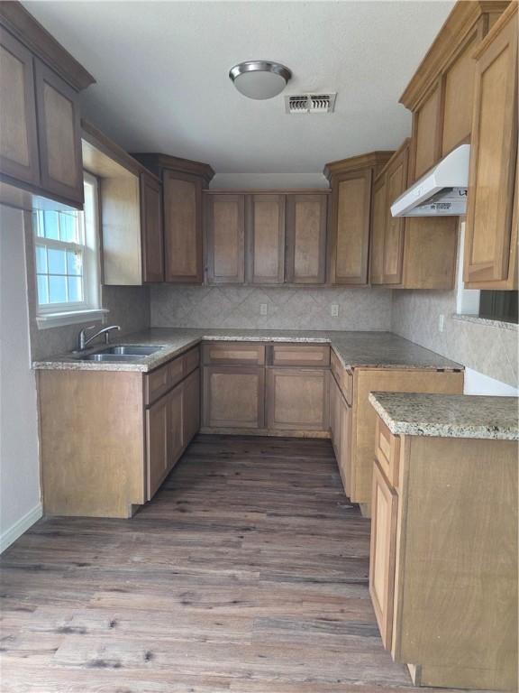2532 Milo Street Corpus Christi, TX 78415 - Photo 4 of 7 a kitchen with granite countertop a sink and cabinets