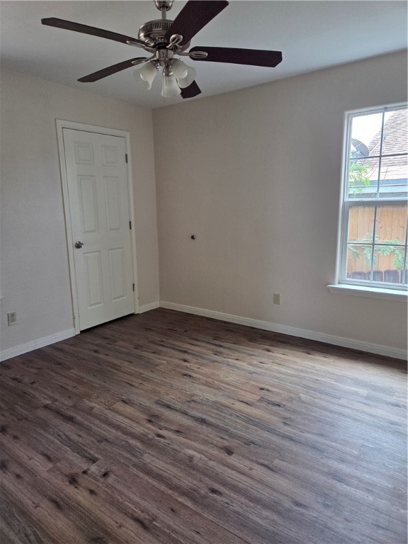2532 Milo Street Corpus Christi, TX 78415 - Photo 5 of 7 an empty room with wooden floor fan and windows