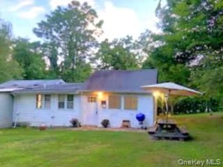 191 Sylvan Lake Road, Unit 1 Hopewell Junction, NY 12533 - Photo 2 of 36 a front view of a house with a garden and trees