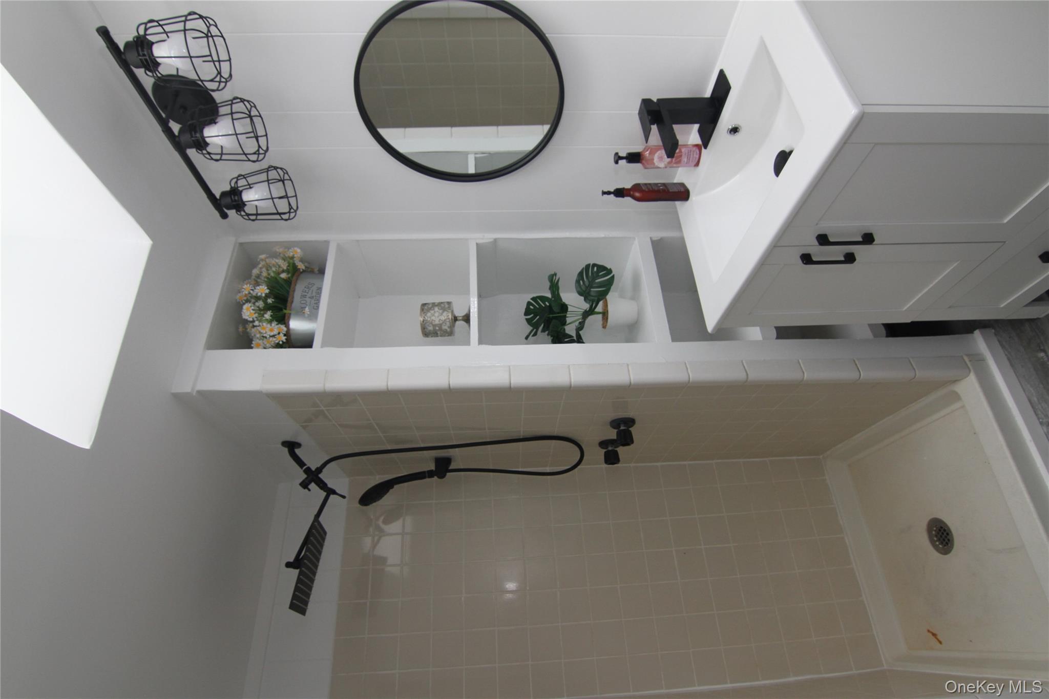 191 Sylvan Lake Road, Unit 1 Hopewell Junction, NY 12533 - Photo 23 of 36 a bathroom with a sink vanity mirror and shower