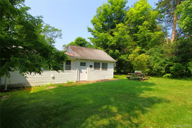 a view of a house with a yard porch and sitting area