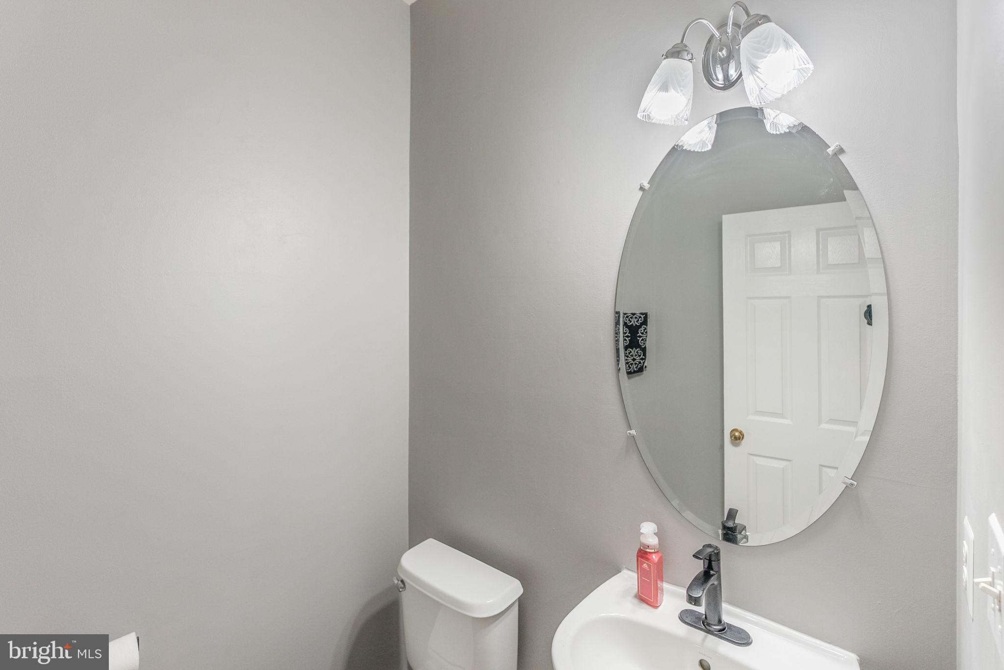 3392 Beechcliff Drive Alexandria, VA 22306 - Photo 13 of 25 a bathroom with a toilet sink and mirror
