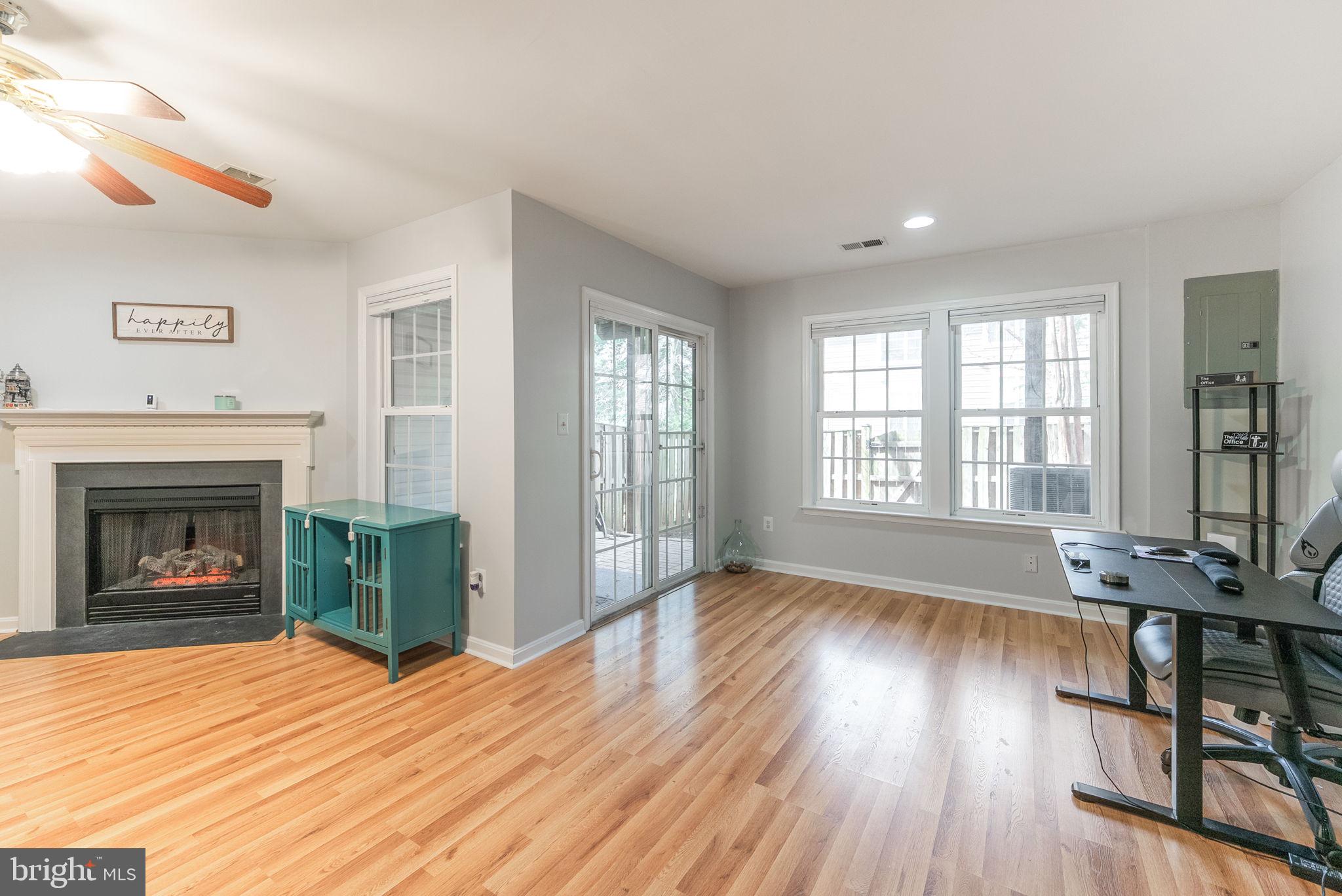 3392 Beechcliff Drive Alexandria, VA 22306 - Photo 20 of 25 wooden floor fireplace and windows in an empty room