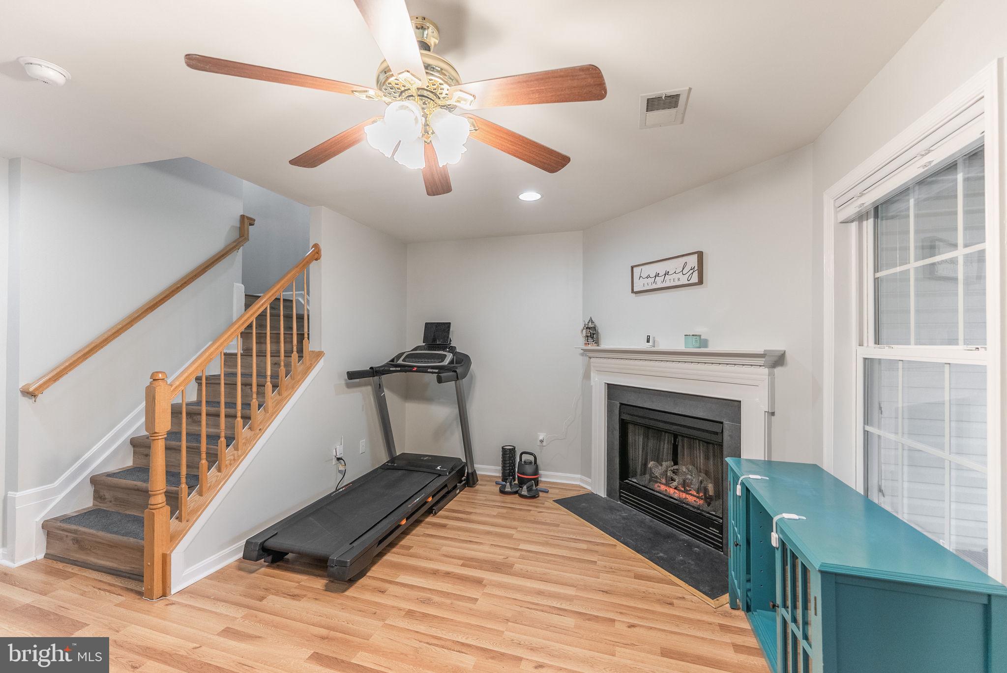 3392 Beechcliff Drive Alexandria, VA 22306 - Photo 21 of 25 a living room with wooden floor and a fireplace