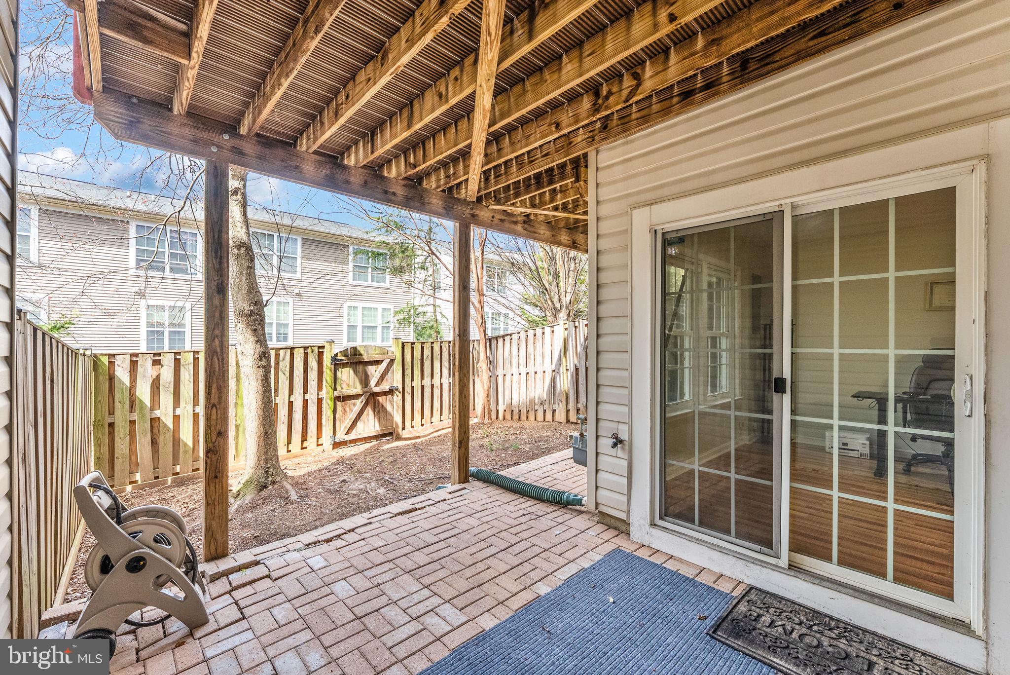 3392 Beechcliff Drive Alexandria, VA 22306 - Photo 24 of 25 a view of a porch with a floor to ceiling window and wooden floor