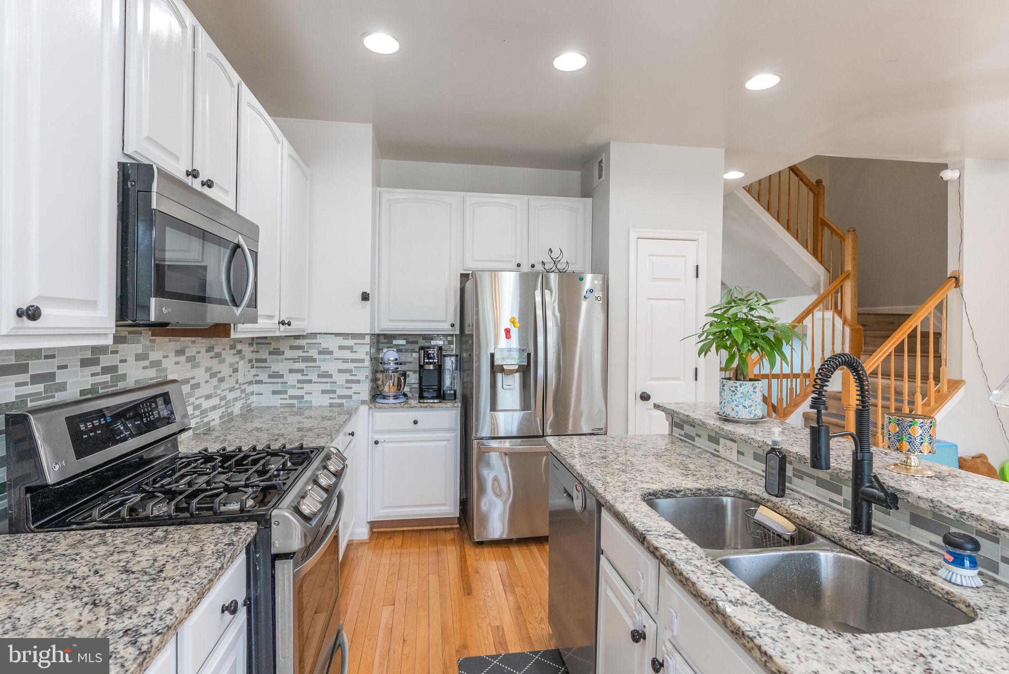 3392 Beechcliff Drive Alexandria, VA 22306 - Photo 9 of 25 a kitchen with a sink stove and refrigerator