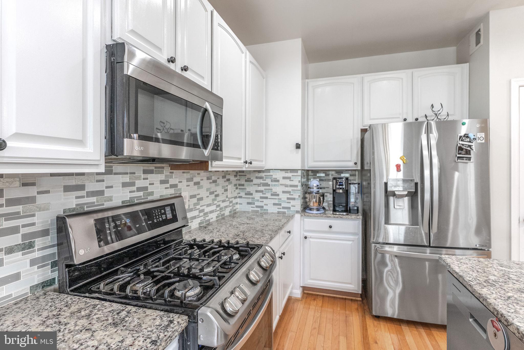 3392 Beechcliff Drive Alexandria, VA 22306 - Photo 10 of 25 a kitchen with a stove a refrigerator and a microwave