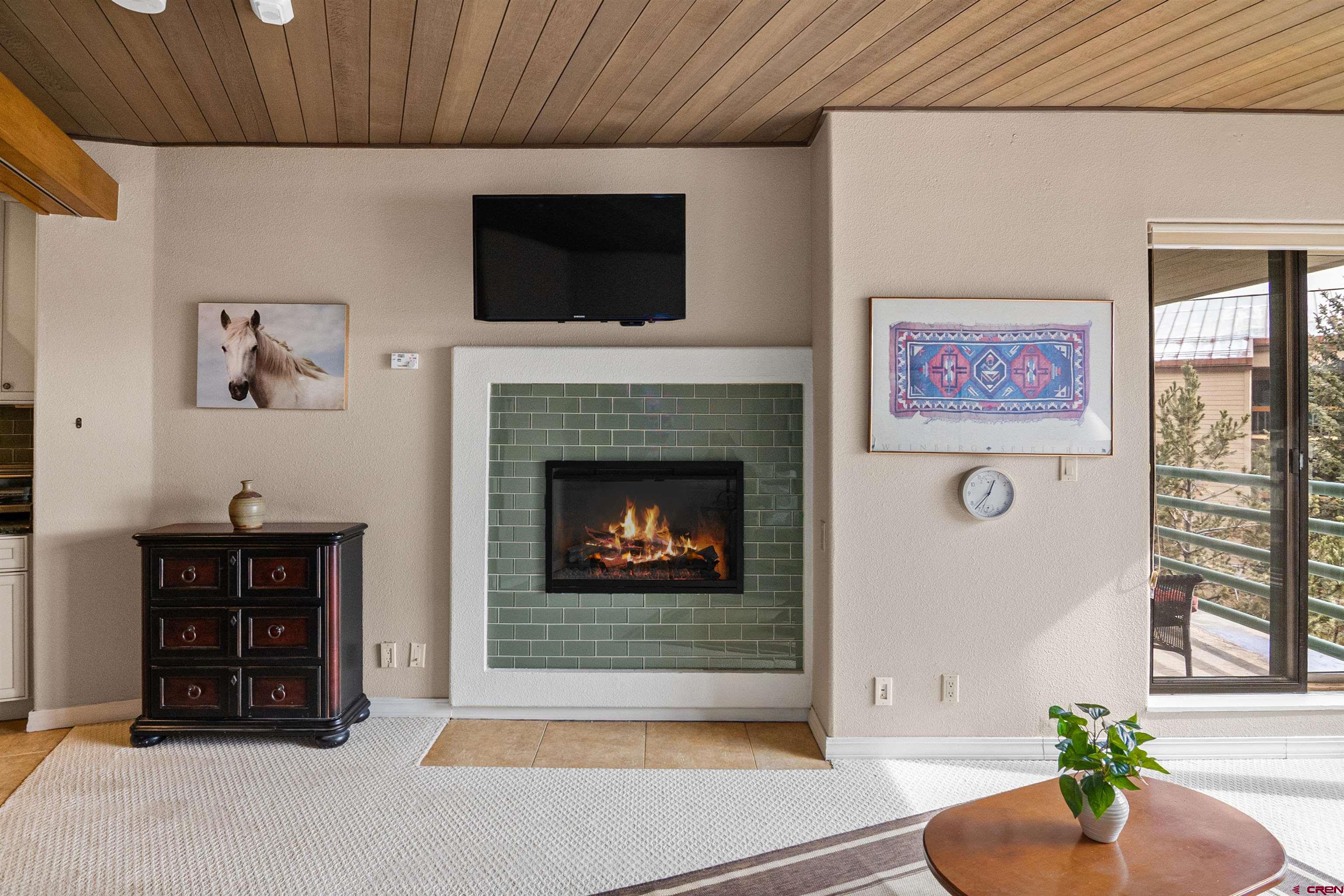 117 Needles Way, Unit 423 Durango, CO 81301 - Photo 16 of 37 a living room with furniture a flat screen tv and a fireplace