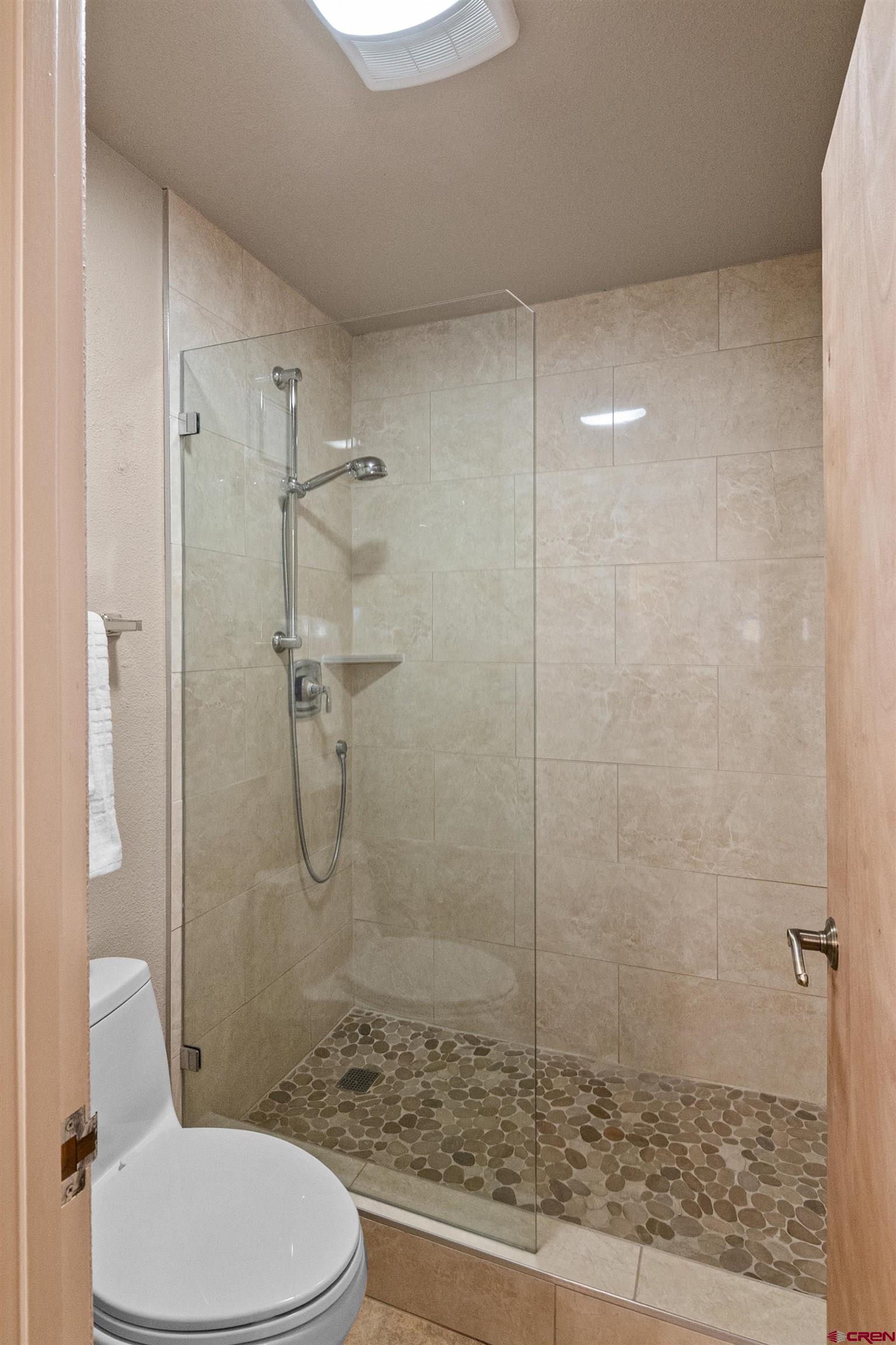 117 Needles Way, Unit 423 Durango, CO 81301 - Photo 20 of 37 a bathroom with a granite countertop toilet a shower and a sink