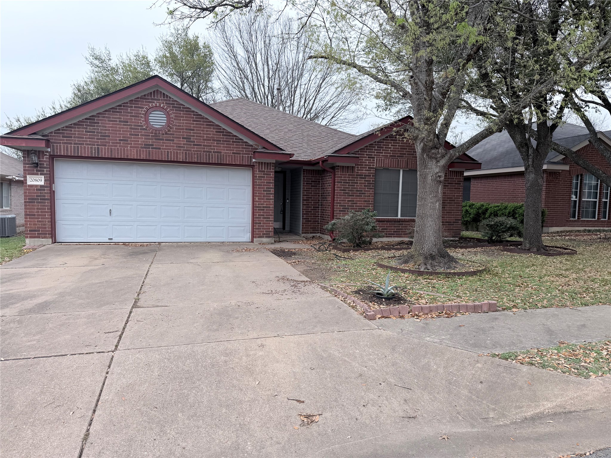 a front view of a house with a yard and trees