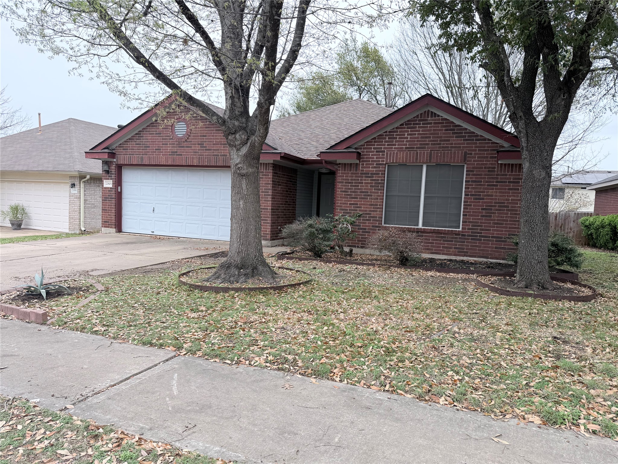 20809 Pacers Gait Lane Pflugerville, TX 78660 - Photo 2 of 23 a front view of a house with garden