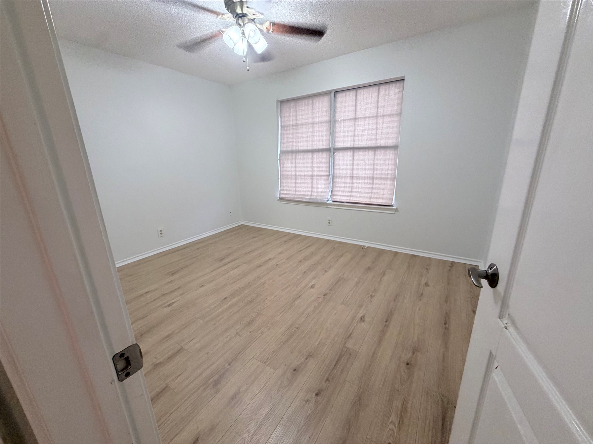 20809 Pacers Gait Lane Pflugerville, TX 78660 - Photo 5 of 23 wooden floor in an empty room with a window