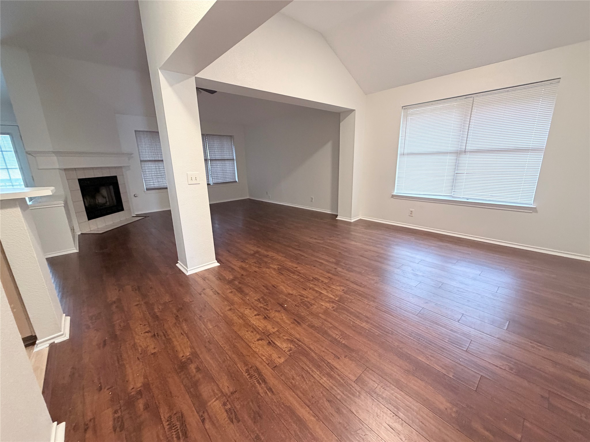 20809 Pacers Gait Lane Pflugerville, TX 78660 - Photo 7 of 23 an empty room with wooden floor and fireplace