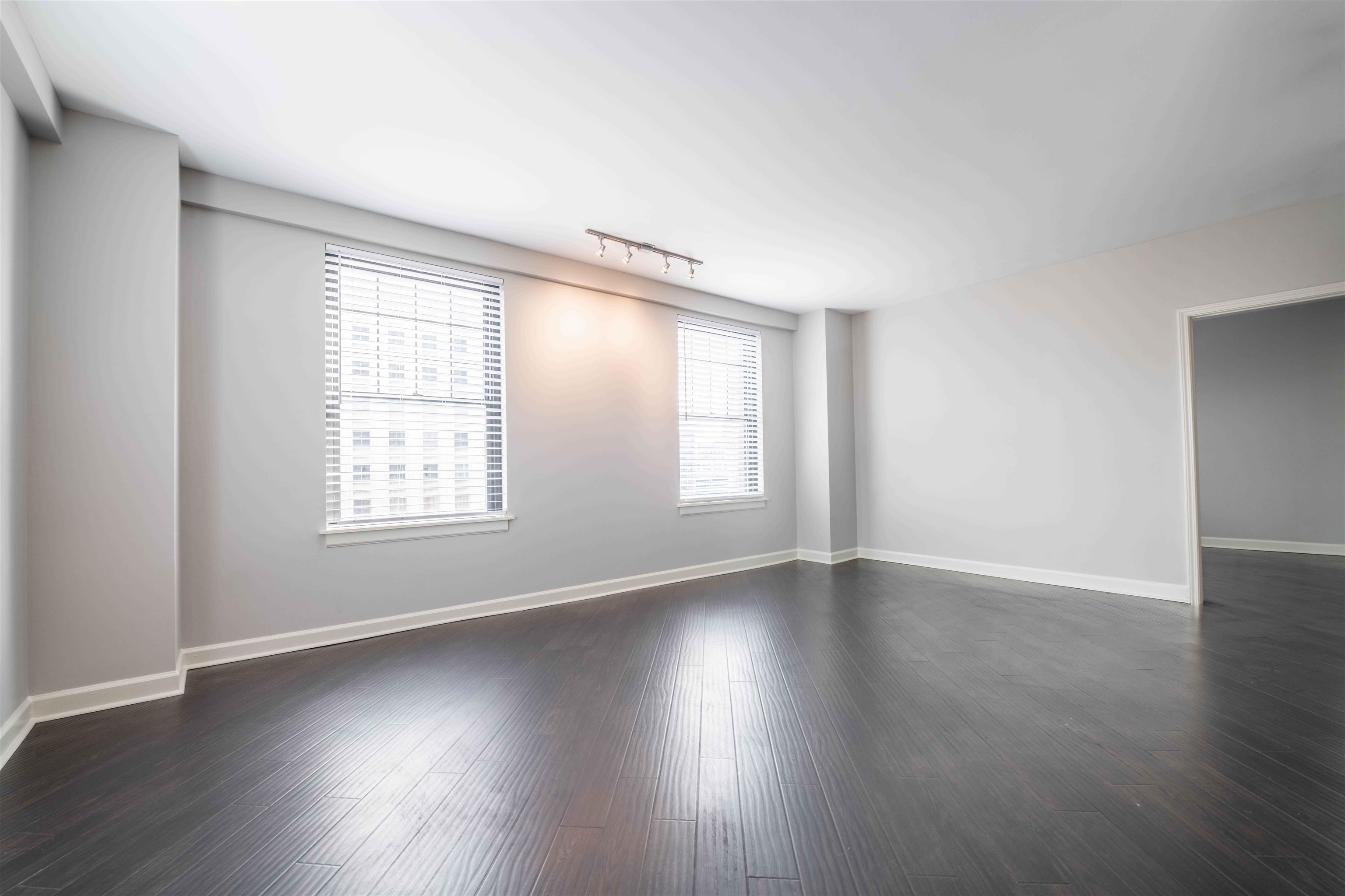 109 North Main Street, Unit 806 Memphis, TN 38103 - Photo 7 of 34 an empty room with wooden floor and windows