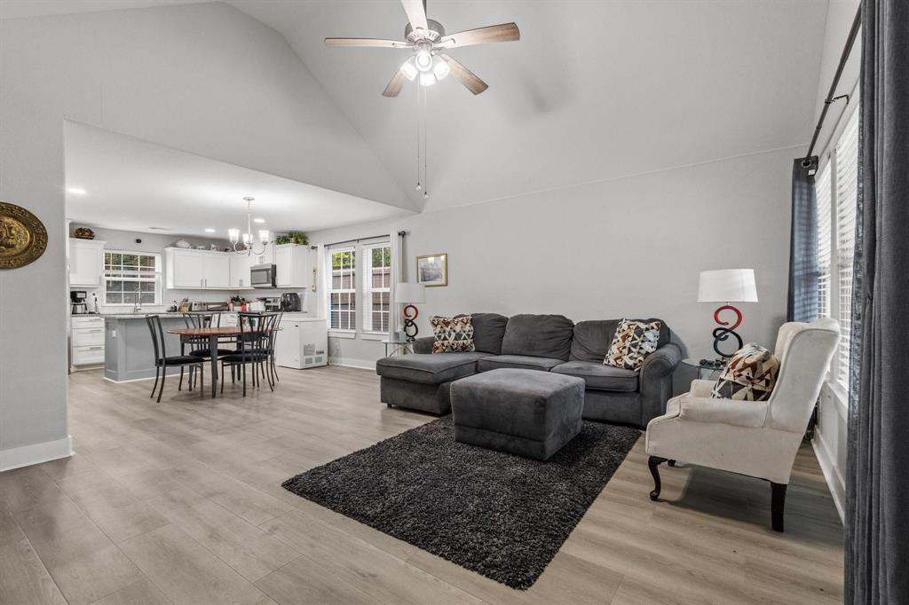 608 East Shepherd Street Denison, TX 75021 - Photo 6 of 31 Open-concept living space featuring wood-finish flooring, vaulted ceilings, and a ceiling fan