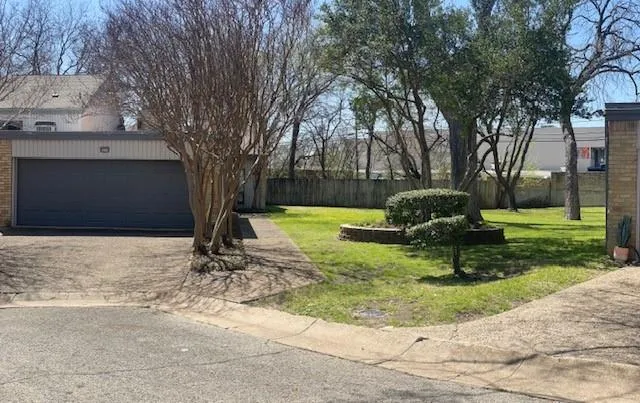 a front view of a house with a yard garage and outdoor seating