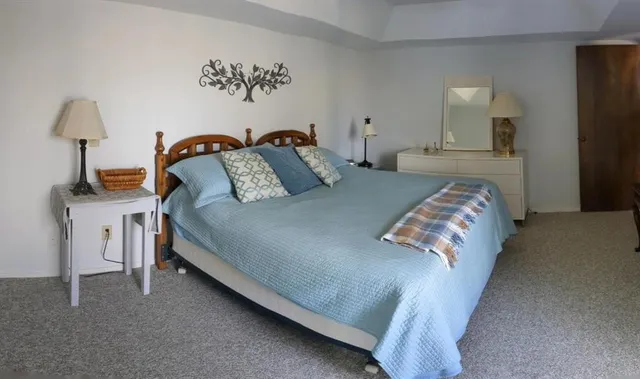 a bedroom with bed and a night stand