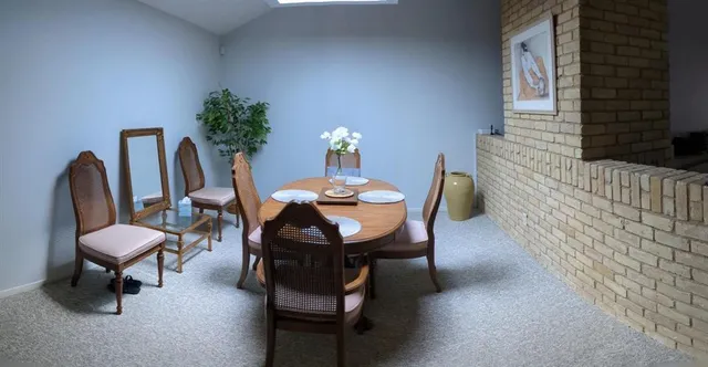 a dining room with furniture and a lamp