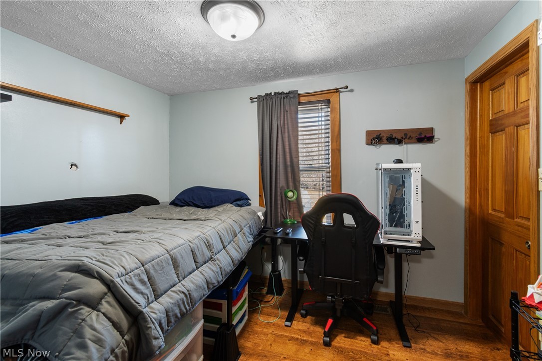 29395 Beitler Road Dennison, OH 44621 - Photo 17 of 33 Bedroom with light wood finished floors and a textured ceiling