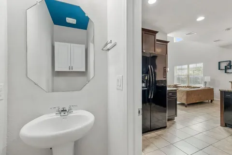 a bathroom with a sink a tub and a mirror