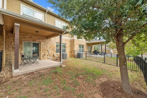 a view of a house with backyard porch and sitting area
