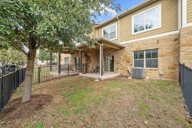a view of a house with backyard and sitting area