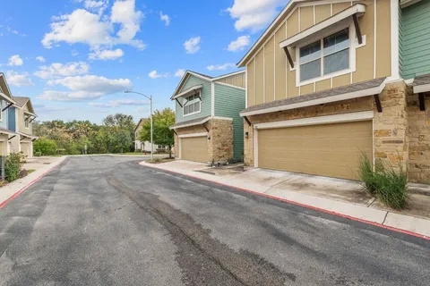 a view of a house with a backyard and garage