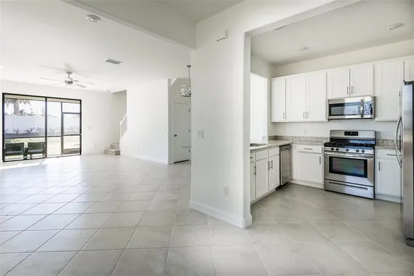 a kitchen with stainless steel appliances and white cabinets