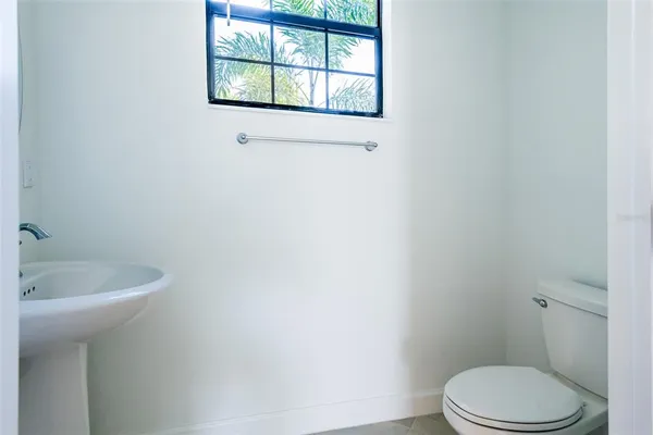 a white toilet sitting next to a bathroom sink