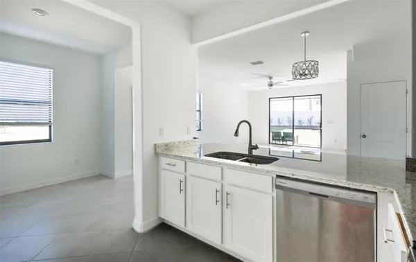 a kitchen with stainless steel appliances granite countertop a sink and a window