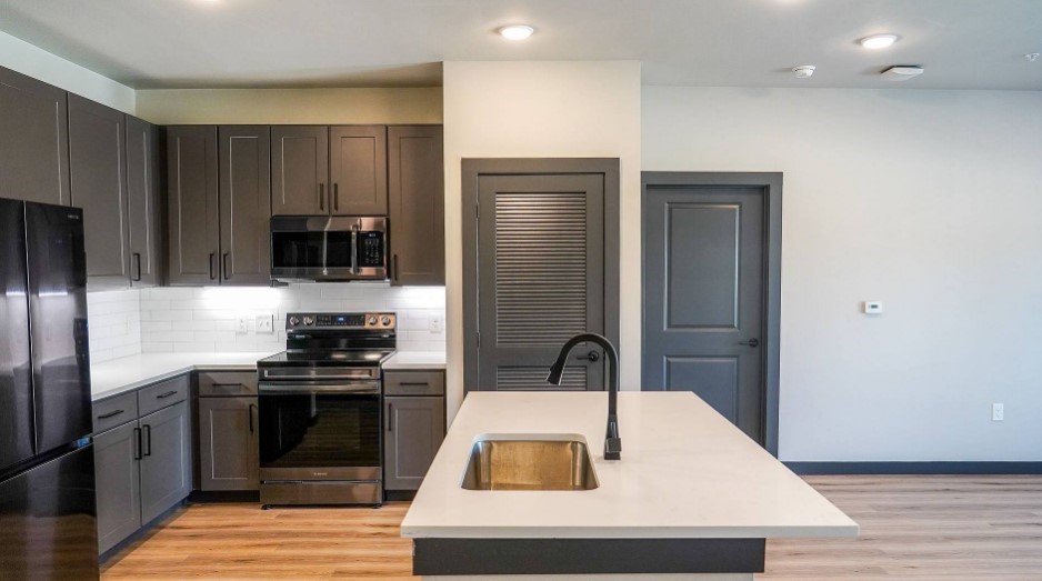 2953 Fm 2920 Rd Spring, Unit 10314 Spring, TX 77388 - Photo 7 of 36 a kitchen with kitchen island a sink stainless steel appliances and cabinets