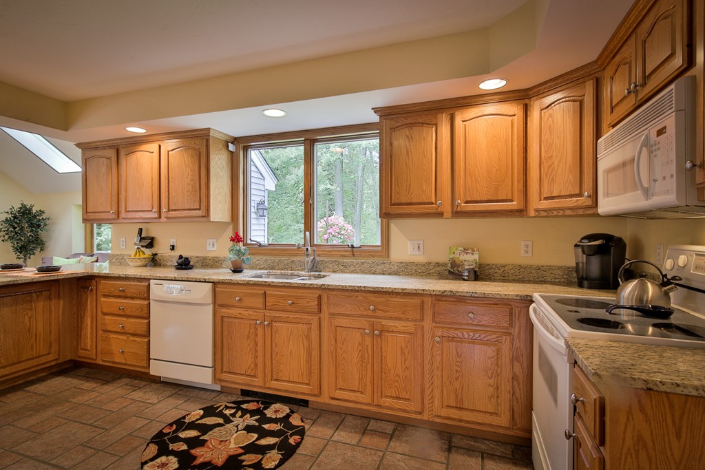49 Porter Road Andover, MA 01810 - Photo 11 of 24 a kitchen with a sink stove and cabinets