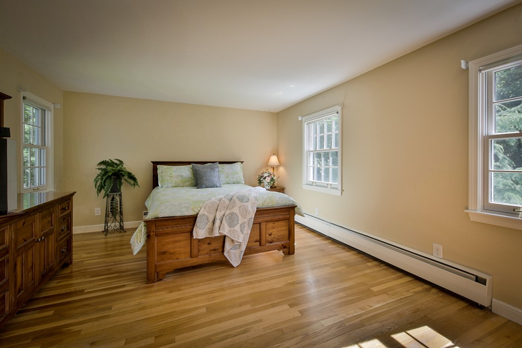 49 Porter Road Andover, MA 01810 - Photo 22 of 24 a bedroom with a bed and wooden floor