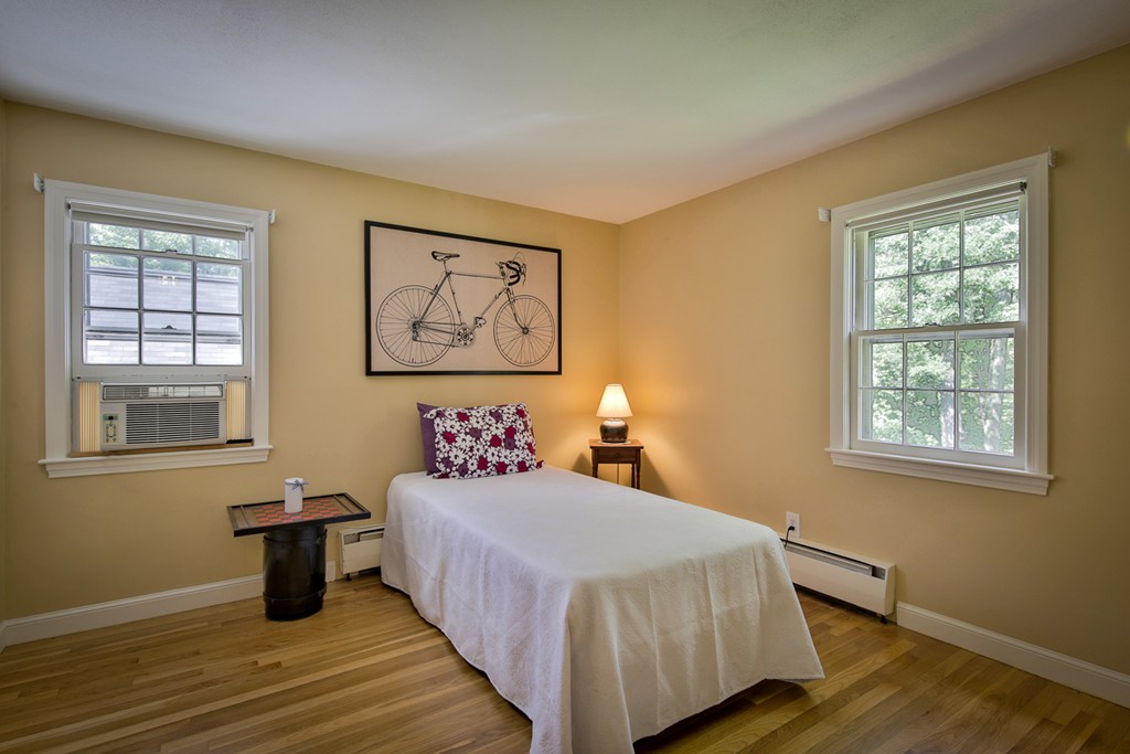 49 Porter Road Andover, MA 01810 - Photo 23 of 24 a bedroom with a bed and wooden floor