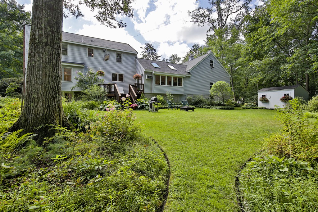 49 Porter Road Andover, MA 01810 - Photo 4 of 24 a aerial view of a house with swimming pool and garden