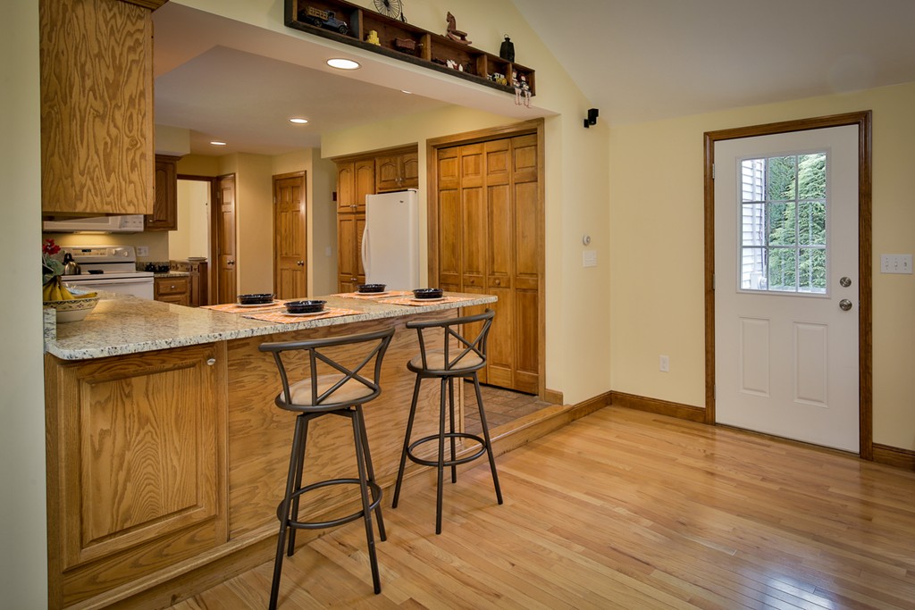 49 Porter Road Andover, MA 01810 - Photo 9 of 24 a kitchen with stainless steel appliances granite countertop a stove a sink and a refrigerator with wooden floor