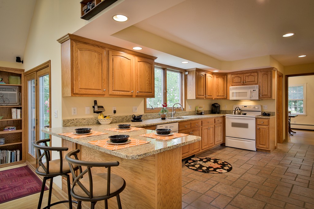 49 Porter Road Andover, MA 01810 - Photo 10 of 24 a kitchen with a sink stove and white cabinets