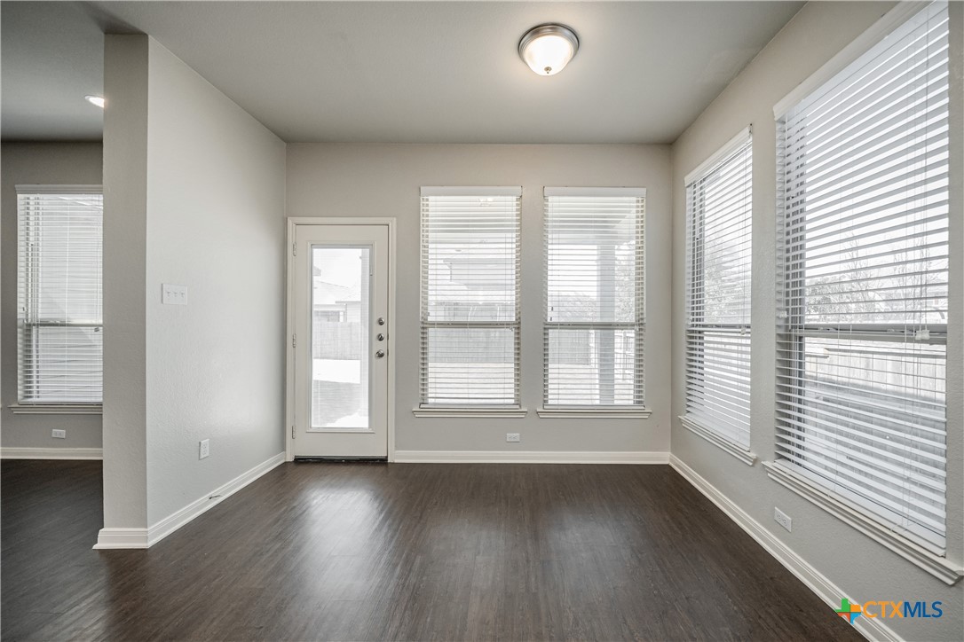 7848 Old Gate Road Temple, TX 76502 - Photo 16 of 32 an empty room with wooden floor and windows
