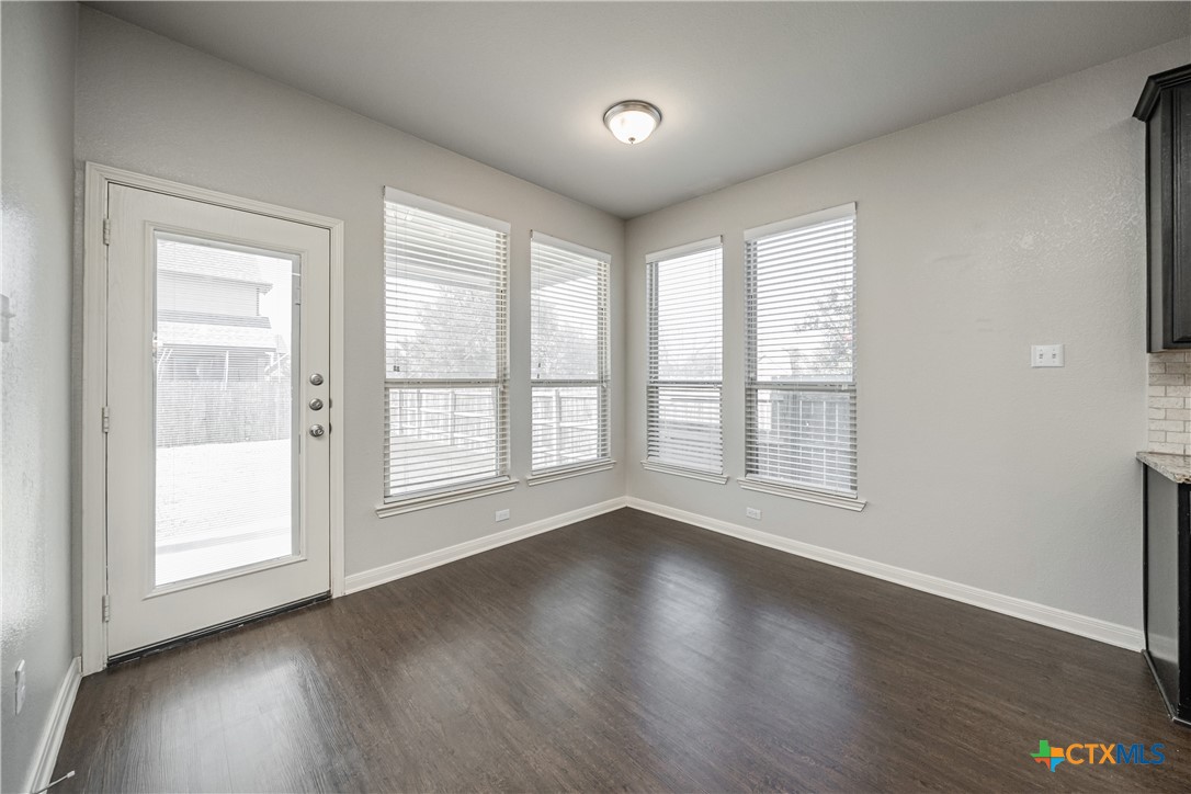 7848 Old Gate Road Temple, TX 76502 - Photo 17 of 32 an empty room with wooden floor and windows