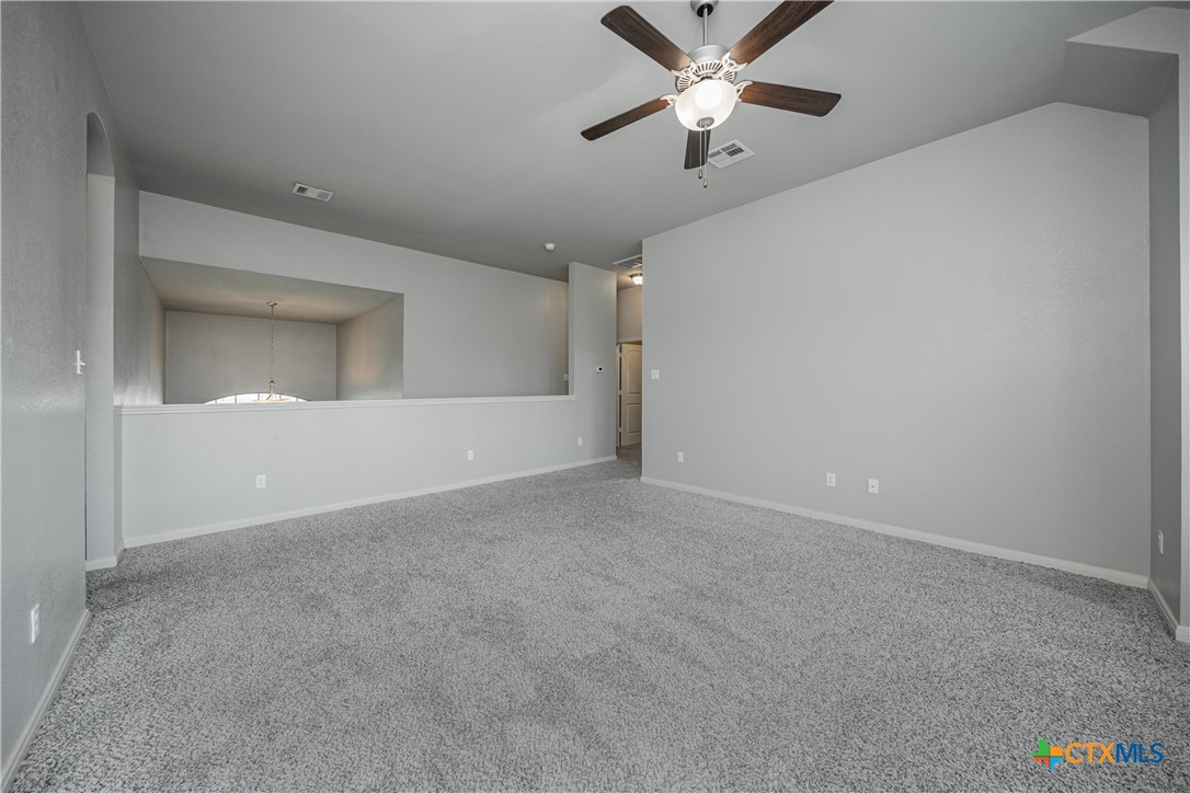 7848 Old Gate Road Temple, TX 76502 - Photo 25 of 32 en empty room with ceiling fan and window