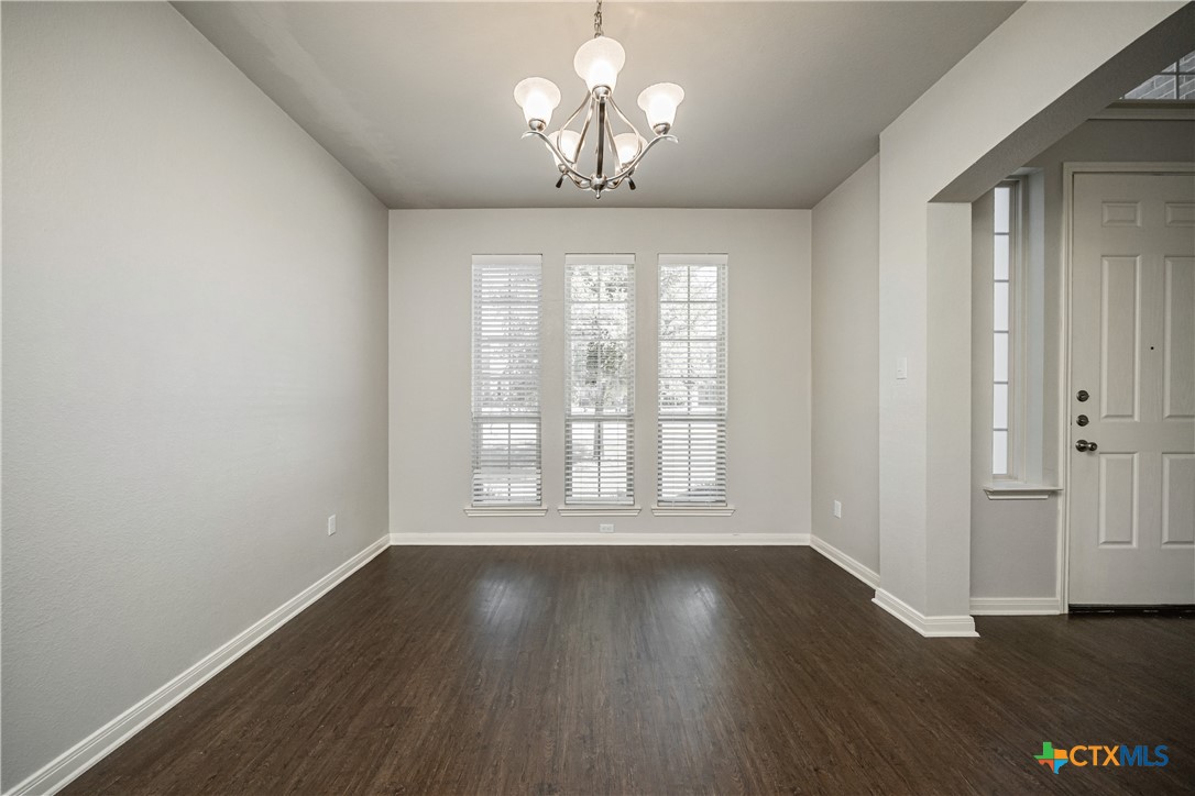 7848 Old Gate Road Temple, TX 76502 - Photo 8 of 32 wooden floor in an empty room with a window