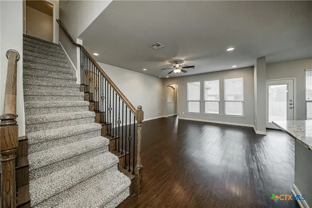 a view of an entryway with wooden floor