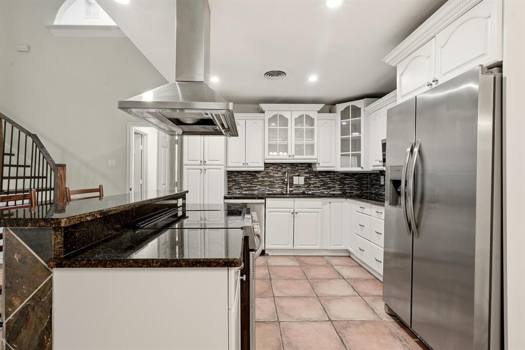 7354 Walling Lane Dallas, TX 75231 - Photo 8 of 28 a kitchen with stainless steel appliances a refrigerator and a stove top oven