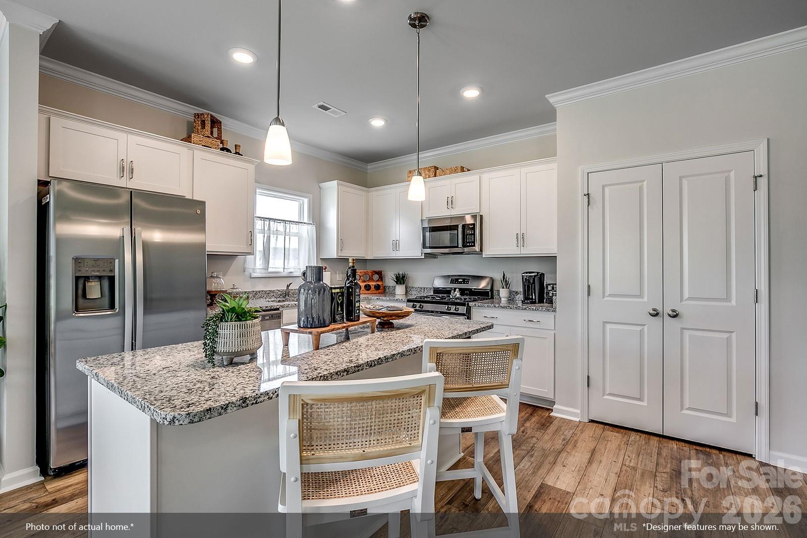 206 Rodeo Drive, Unit 25 Shelby, NC 28150 - Photo 2 of 9 a kitchen with kitchen island granite countertop a center island stainless steel appliances cabinets and a counter top space